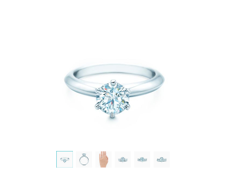 Un maravilloso diamante en talla brillante redondo descansa delicadamente en un anillo cónico.