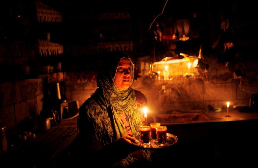 Una mujer palestina prepara café en medio de la oscuridad por el corte eléctrico en la franja de Gaza