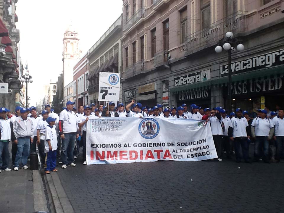 Marcha de trabajadores por las calles del centro de Puebla.