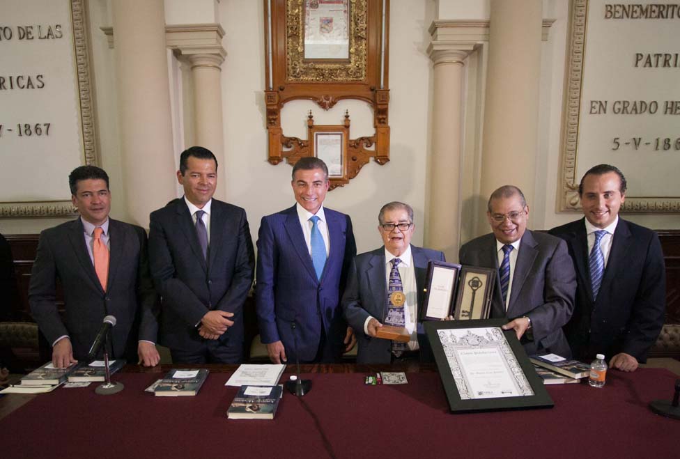 El galardonado en compañía de autoridades municipales y estatales.