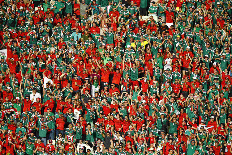 Decenas de aficionados mexicanos apoyan a la selección dirigida por Miguel Herrera durante el partido contra los brasileños en el estadio Castelao, en