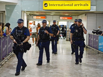 Oficiales de policía británicos, en la sala de llegadas internacionales del aeropuerto de Heathrow, en Londres