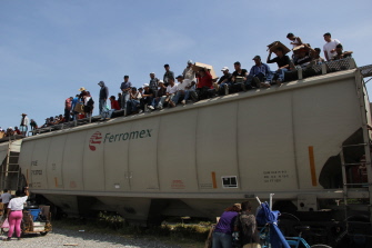 Inmigrantes centroamericanos, sentados en un vagón del tren de carga llamado La Bestia, en Arriaga, en el estado de Chiapas