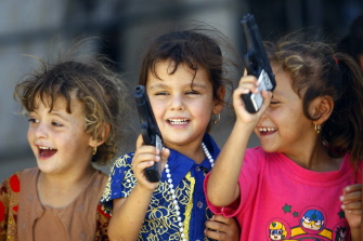 Niños chiitas iraquíes que debieron huir con sus familias de Mosul juegan con pistolas de juguete en la fiesta del Eid al-Fitr en Najaf 