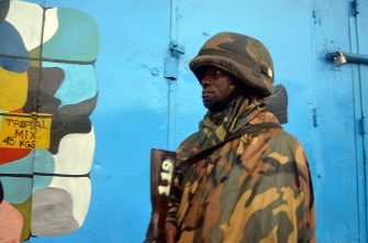 Un soldado liberiano hace guardia ante una tienda cerrada en un barrio de Monrovia, como parte de las medidas para contener el Ébola