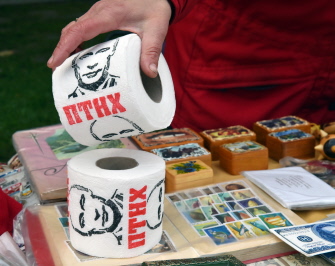 Una vendedora de recuerdos enseña sus productos más populares, como el papel higiénico con la imagen del presidente ruso Putin, en Kiev