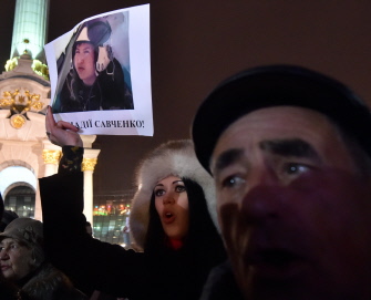 Una joven muestra un retrato de la piloto ucraniana Nadiya Savchenko, capturada por los rebeldes prorrusos, en reclamo de su libertad, en Kiev