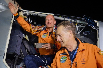 El piloto suizo Bertrand Piccard (i), saluda al salir del Solar Impulse 2 en Ahmedabad, al lado de su compatriota, el copiloto André Borschberg