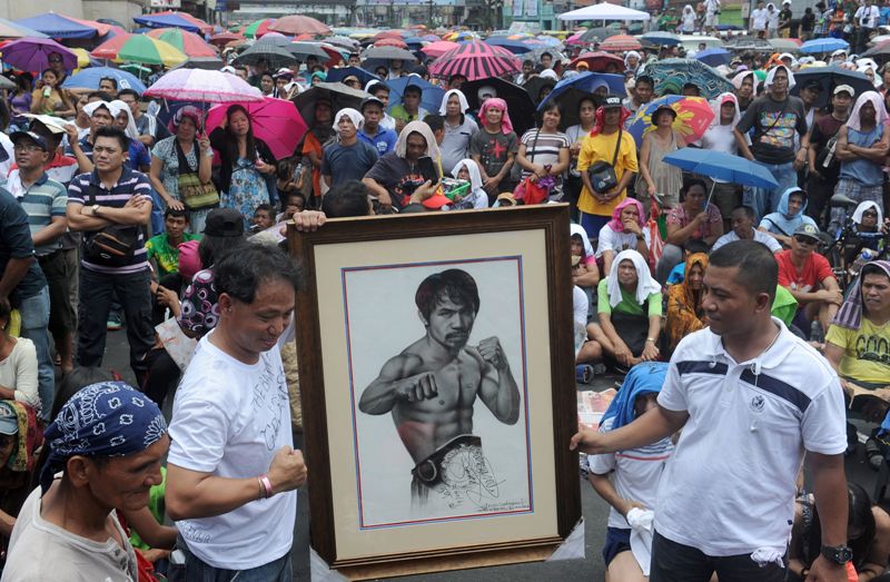 Aficionados con la imagen de Manny Pacquiao en Filipinas 