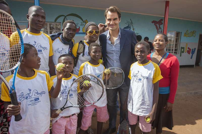 Roger Federer con niños que son beneficiados por su fundación  