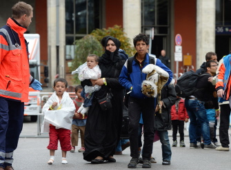 Una familia de refugiados se dirige a un primer control médico tras su llegada a la estación ferrocarrilera de Munich, en el sureste de Alemania