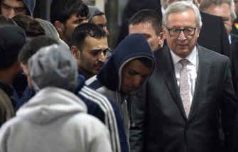 Jean-Claude Juncker (d), presidente de la CE, camina junto a migrantes en un puesto de control policial alemán en Passau, Baviera