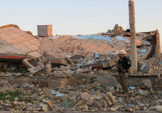 Un militar iraquí permanece entre los escombros de edificios destruidos en el área de Husayba al-Sharkiya, al este de Ramadi, capital de Anbar