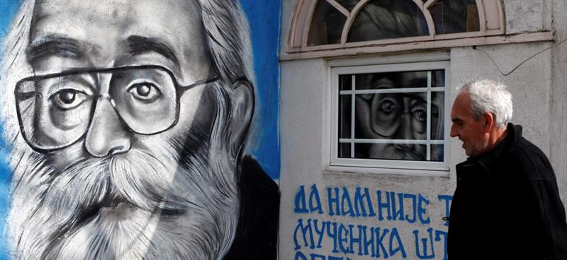 Un hombre pasa junto una pared decorada con un grafiti del ex líder serbobosnio Radovan Karadzic, en Belgrado, Serbia