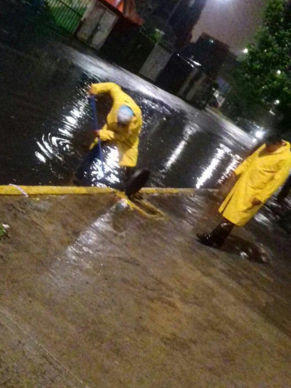 Personal de la delegación Iztapalapa retira la basura de las alcantarillas que se taparon. 