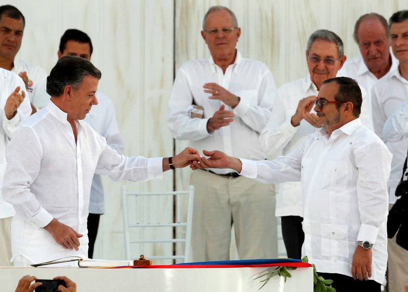 El presidente Juan Manuel Santos y el líder de la guerrilla, Rodrigo Londoño, alias "Timochenko", firmaron el lunes un acuerdo que de ser refrendado p