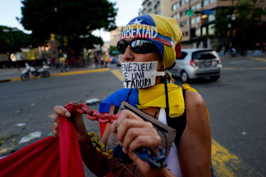 Una activista y opositora al gobierno de Nicolás Maduro participa en una marcha contra lo que llaman "dictadura".