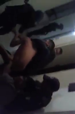 Uno de los policías toma del cuello al detenido. (Foto Redes)