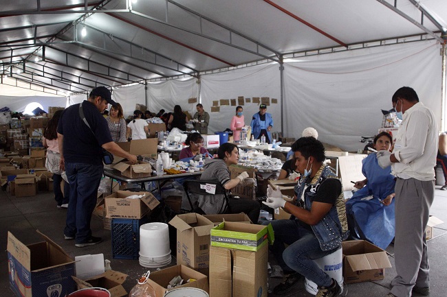 El personal construye paquetes para entregarlos en la zonas afectadas por el sismo.