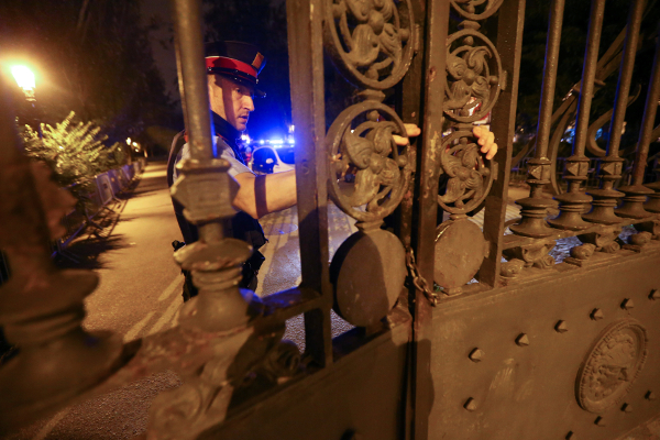 Un oficial de policía regional de Cataluña cierra la puerta que conduce a la Asamblea Regional de Cataluña.