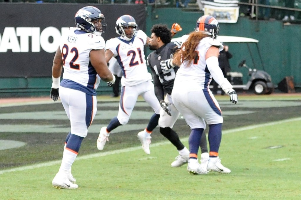 Michael Crabtree y Aqib Talib