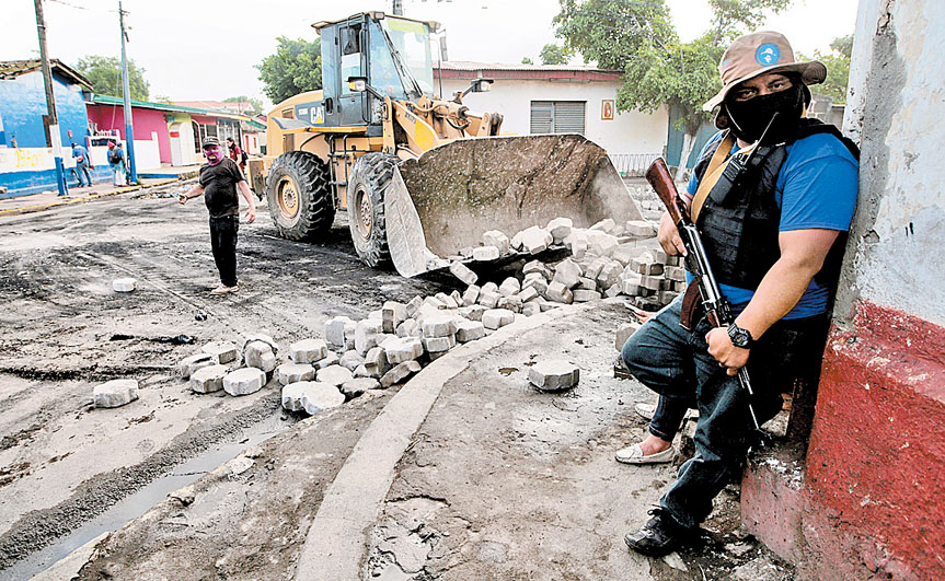 Paramilitar vigila calles del barrio indígena de Moninbó, de la ciudad de Masaya. (Oswaldo Rivas/Reuters)