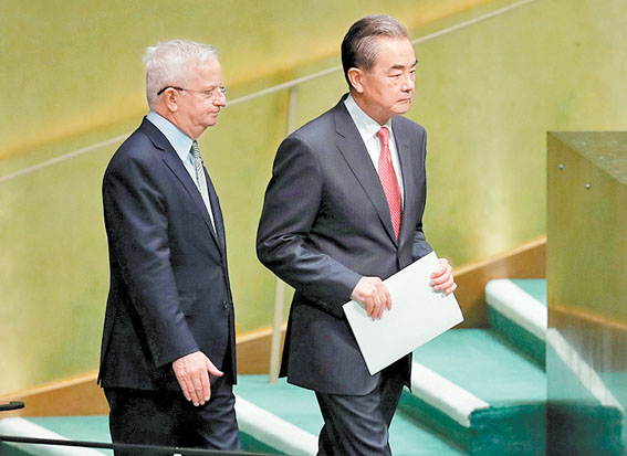 El canciller chino, Wang Yi, es acompañado antes de su discurso. (Carlo Allegri/Reuters)