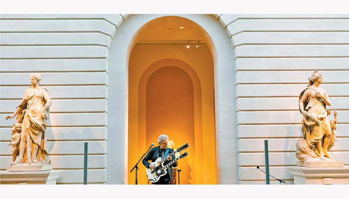 Steven Miller y su guitarra de doble mástil en la presentación de la muestra. JUSTIN LANE/EFE