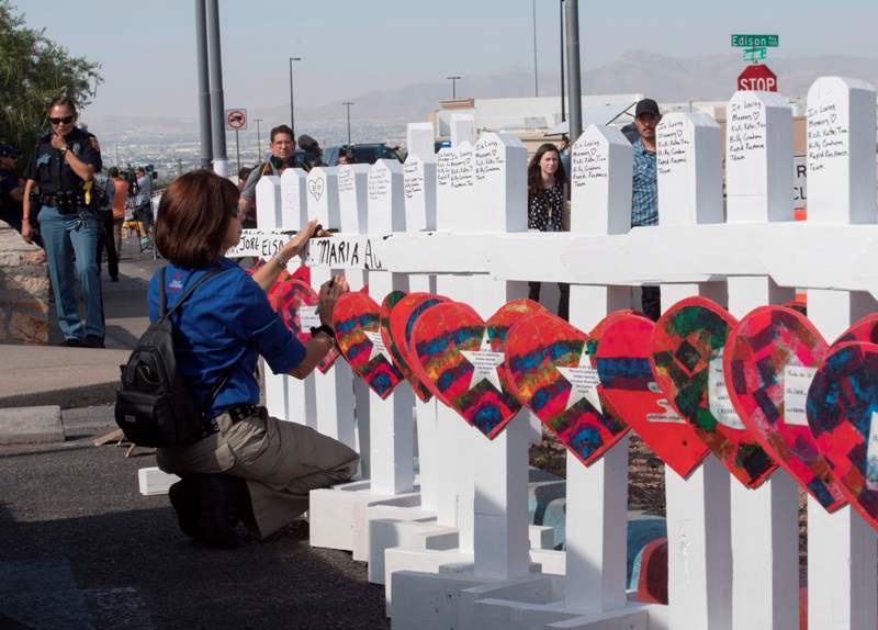 Miembros del grupo 'Crosses for Losses' colocan una cruz por cada víctima, en El Paso. (AFP)