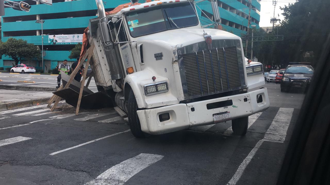 La llanta del torton cayó en el socavón cuando  circulaba por avenida Cuauhtémoc y Morena. (Gabriel Ortega)