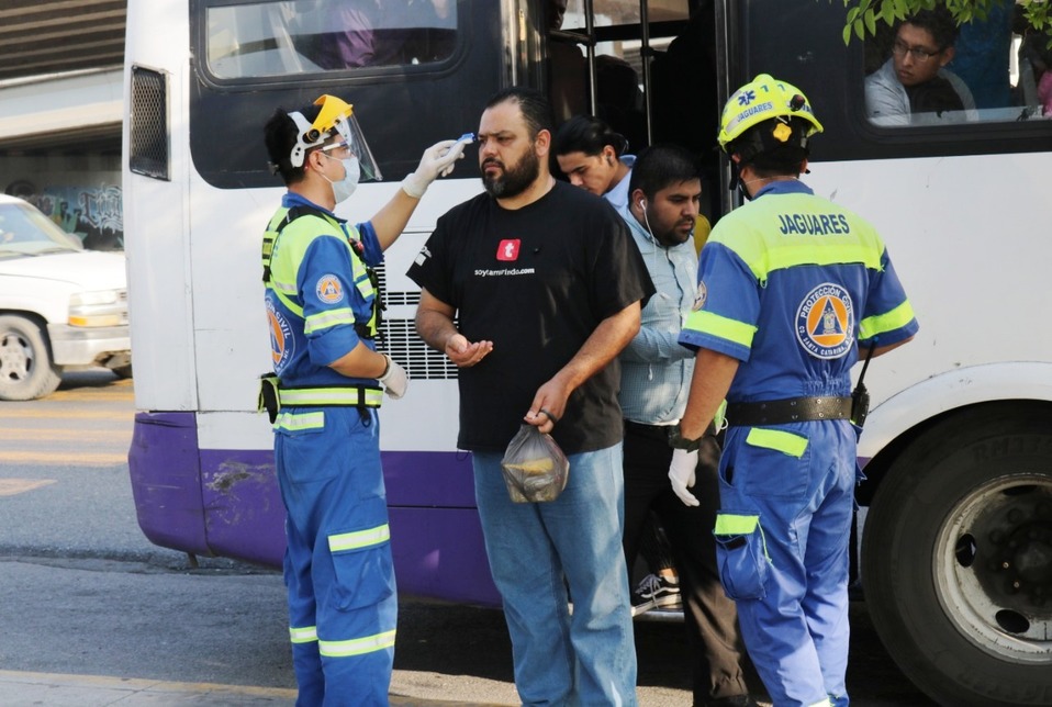 Los elementos de Protección Civil del Grupo Jaguares toman la temperatura a los usuarios.