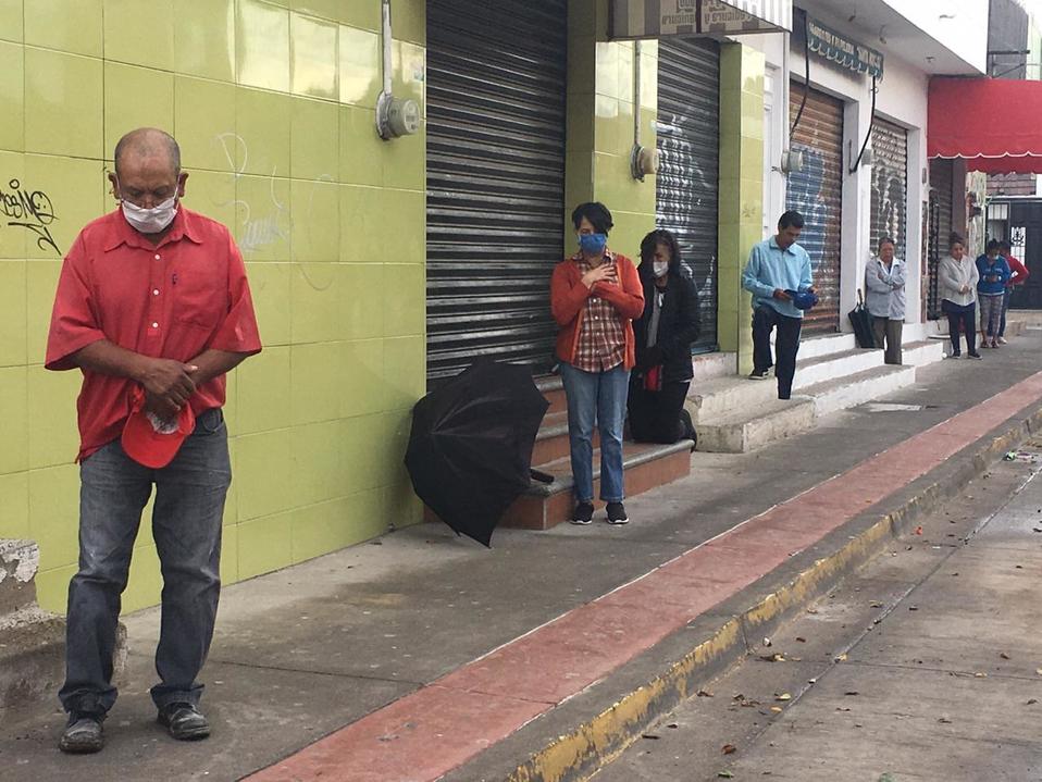 En León, vecinos de San Pedro Plus escuchan misa con sana distancia.