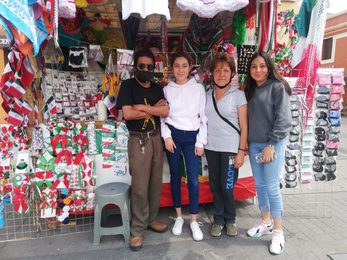 Melisa Islas Rosales y su familia atienden su puesto de artículos patrios. (Elizabeth Hernández)