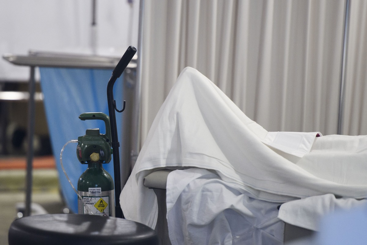 Tanque de oxígeno al pie de un paciente sospechoso de Covid-19, en una carpa fuera del departamento de emergencias del hospital MLK. Foto: Patrick Fal