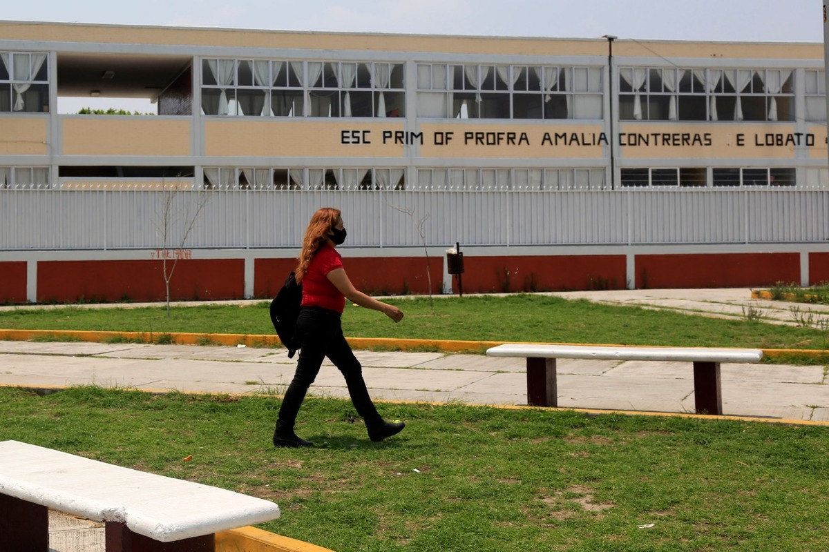 Una mujer camina frente a una primaria al sur de la ciudad. (Andrés Lobato)