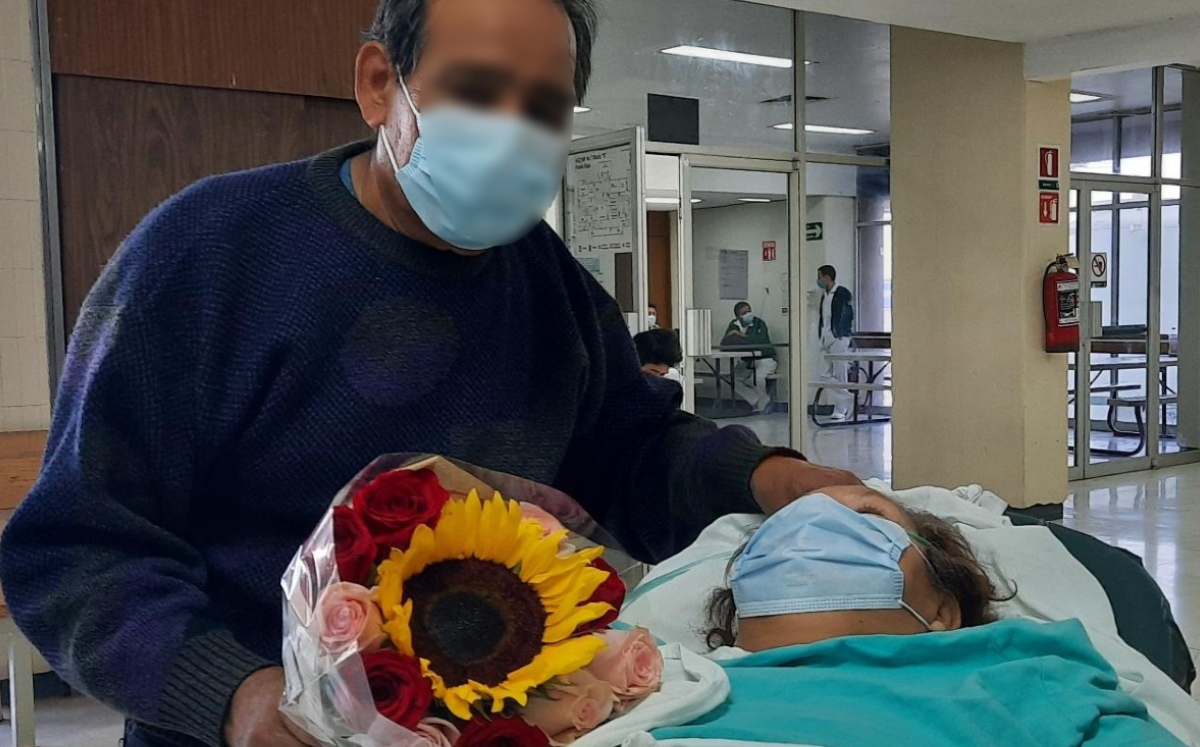 Con flores, hombre llega a hospital por su esposa tras superar covid-19. (Especial)