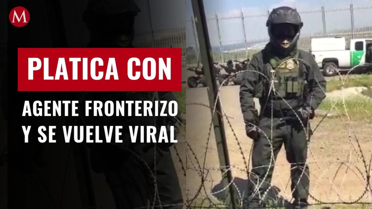 Joven mexicano platica con agente fronterizo en el muro entre México y EU
