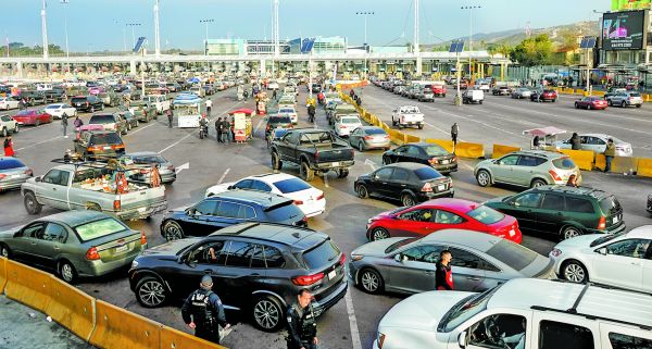 Automovilistas mexicanos esperan su turno para cruzar por la la garita que conecta Tijuana con San Ysidro. EFE