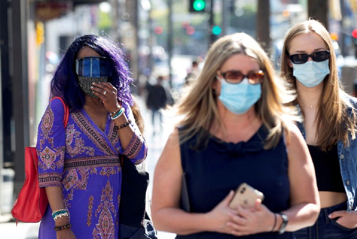 Mujeres caminan sobre Hollywood Blvd, en Los Ángeles, usando mascarillas anticovid. | Reuters