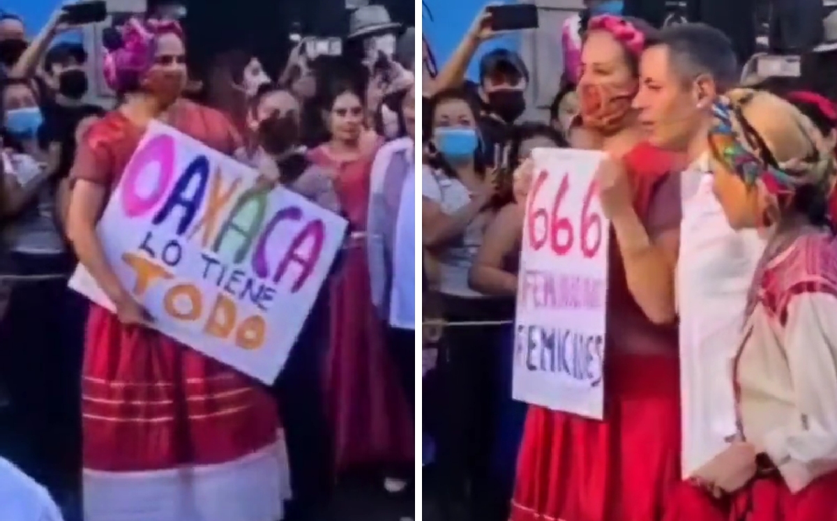 La mujer mostró un cartel con la leyenda "666 feminicidios" en su foto con Alejandro Murat. | Especial