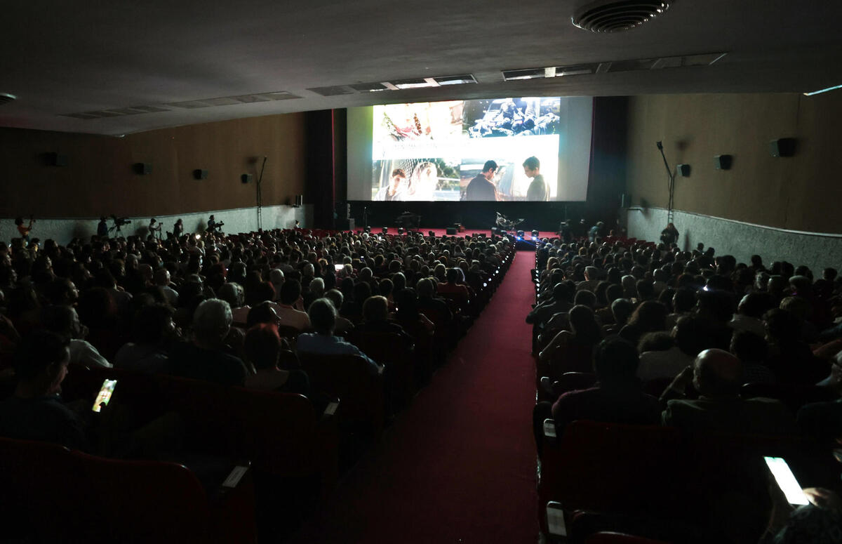 Grupos de personas asisten a una proyección en la inauguración del Festival Internacional del Nuevo Cine Latinoamericano. (EFE)
