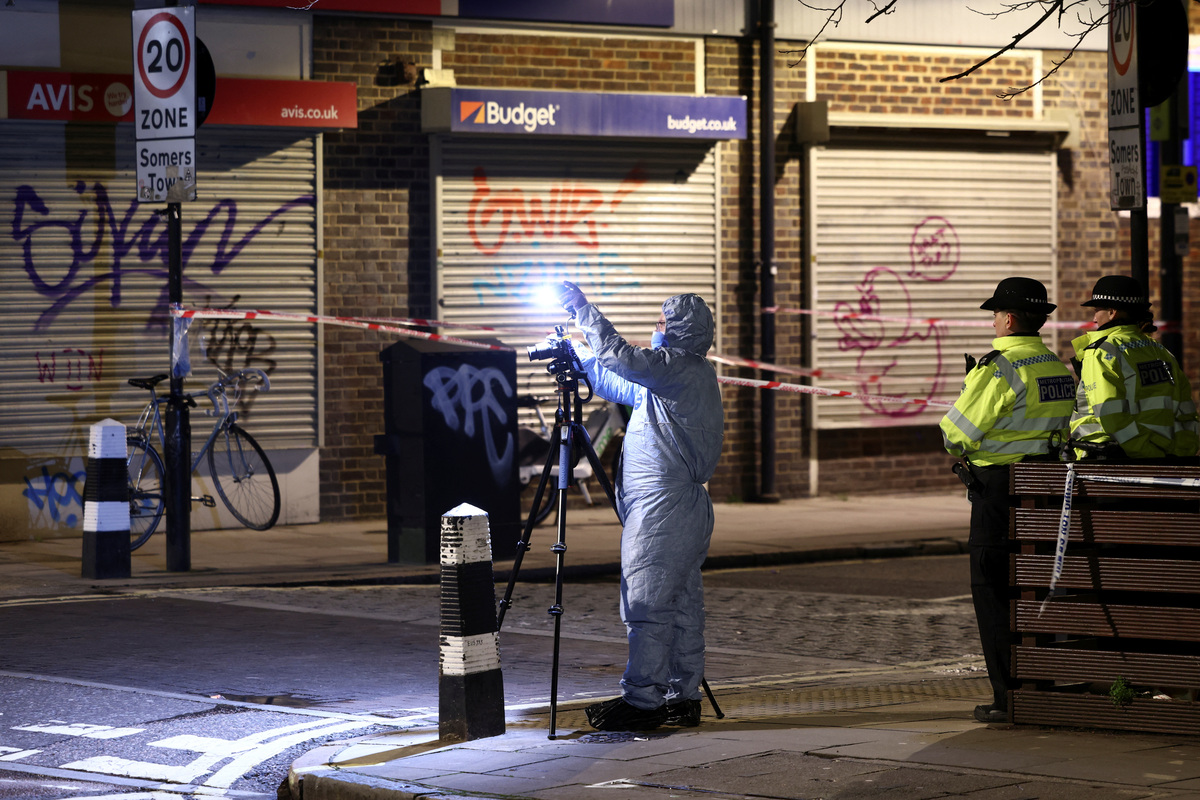 Oficial forense trabaja en la escena de un tiroteo, el ataque ocurrió durante un funeral en la Iglesia de San Aloysius, Londres. (Reuters)