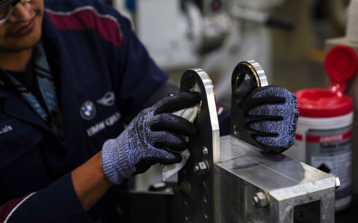 Un trabajador limpia pieza de un coche BMW en la planta de la automotriz alemana BMW en San Luis. Foto: (Reuters)