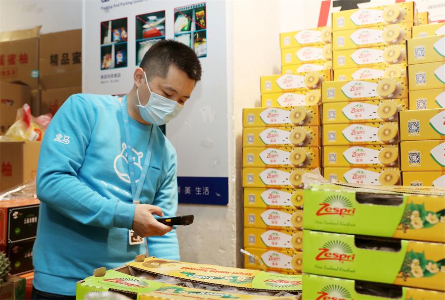 Wang Longchi revisa información en el área de servicio de pedidos en línea de una tienda de Hema Fresh en Pudong, en Shanghái. (Xinhua/Liu Ying)