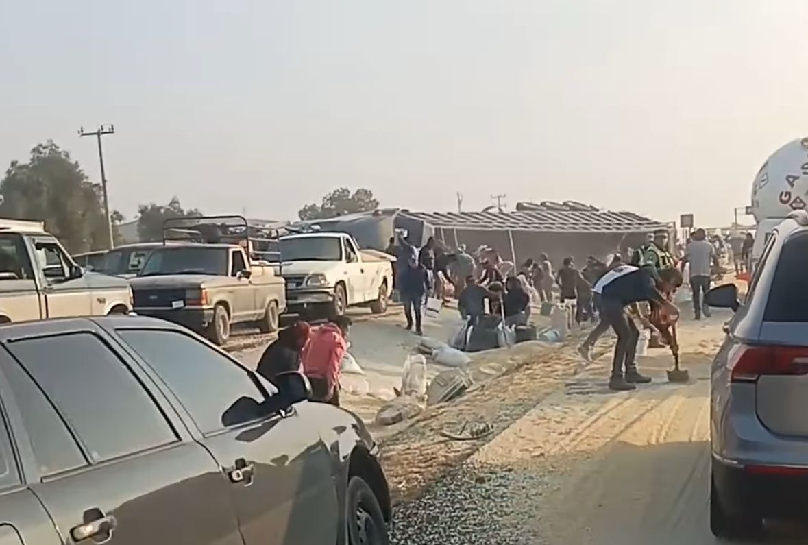 Toneladas de maíz quedaron regadas tras una volcadura. (Captura)
