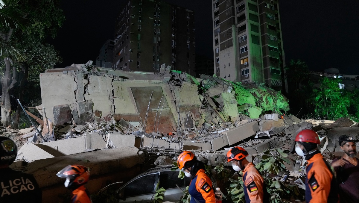 Trabajadores de rescate buscan entre los escombros de un edificio derruido tras un sismo en Caracas, Venezuela. | AP