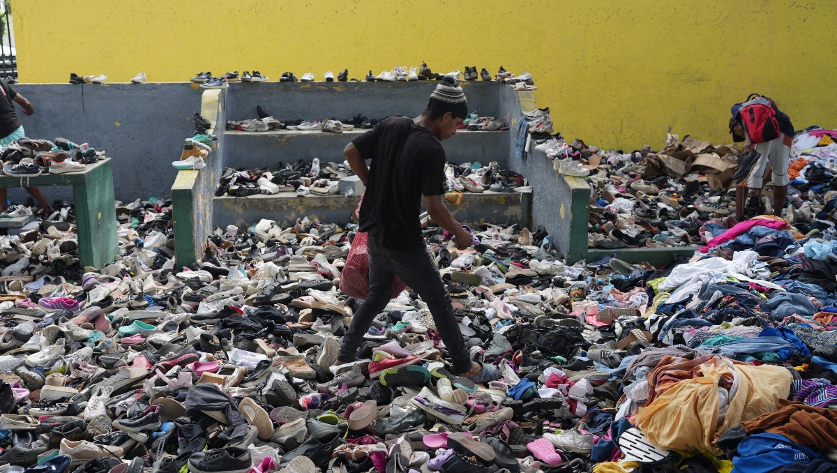 Persona elige entre ropa donada a los damnificados por los terremotos en un complejo deportivo, el sábado 4 de julio de 2026, en La Guaira. | AP
