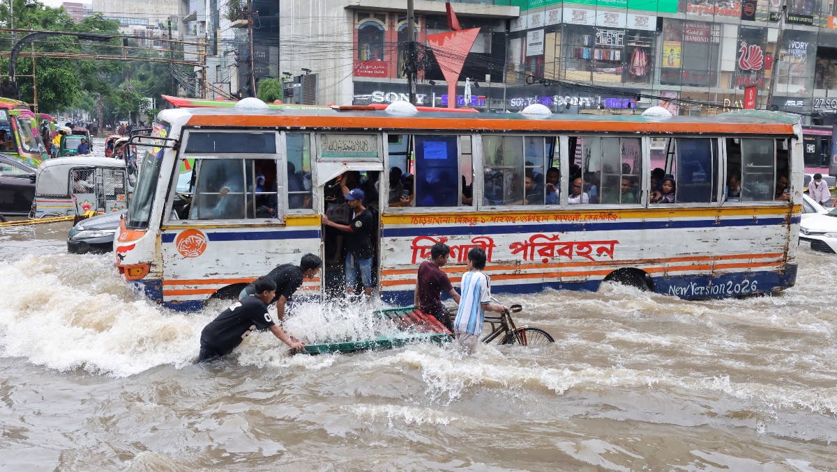 Vehículos circulan por una calle inundada tras las lluvias torrenciales en Daca, Bangladés | Foto: Reuters