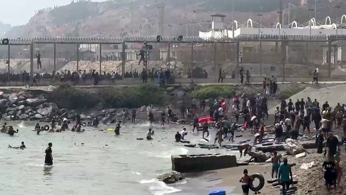 Migrantes que llegan a la costa del enclave español de Ceuta, en el norte de África, después de nadar alrededor de la valla fronteriza. | AFP