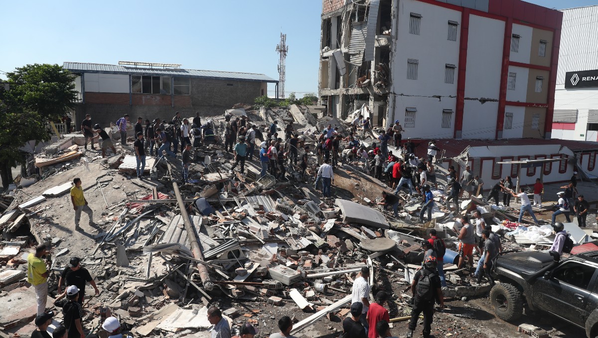 Residentes y equipos de rescate buscan entre los escombros de un edificio derrumbado tras el terremoto que azotó Cali, Colombia. | AP